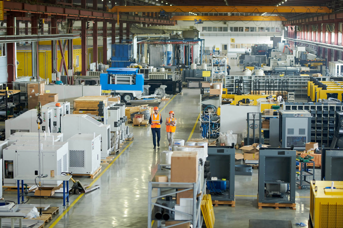 Factory interior with machinery and workers in a large industrial setting